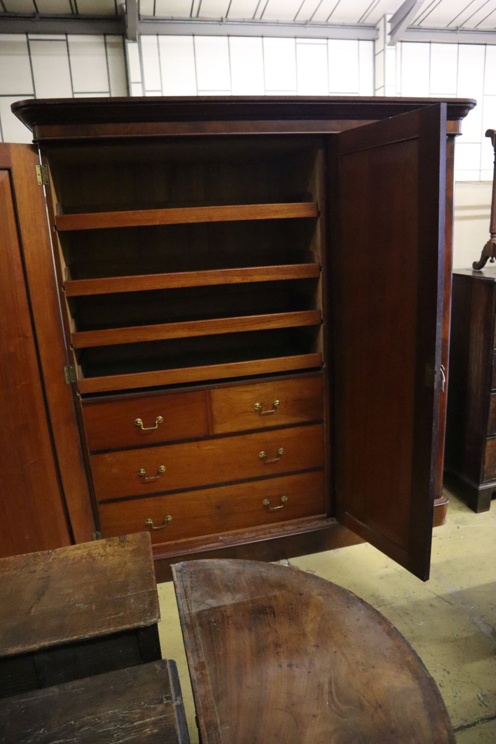 A Victorian mahogany three door wardrobe, with a central mirrored door, width 190cm depth 60cm height 208cm